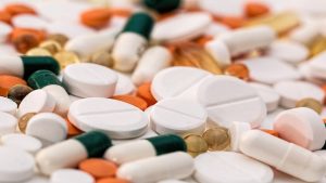 Aspirin tablets and pills scattered on a surface